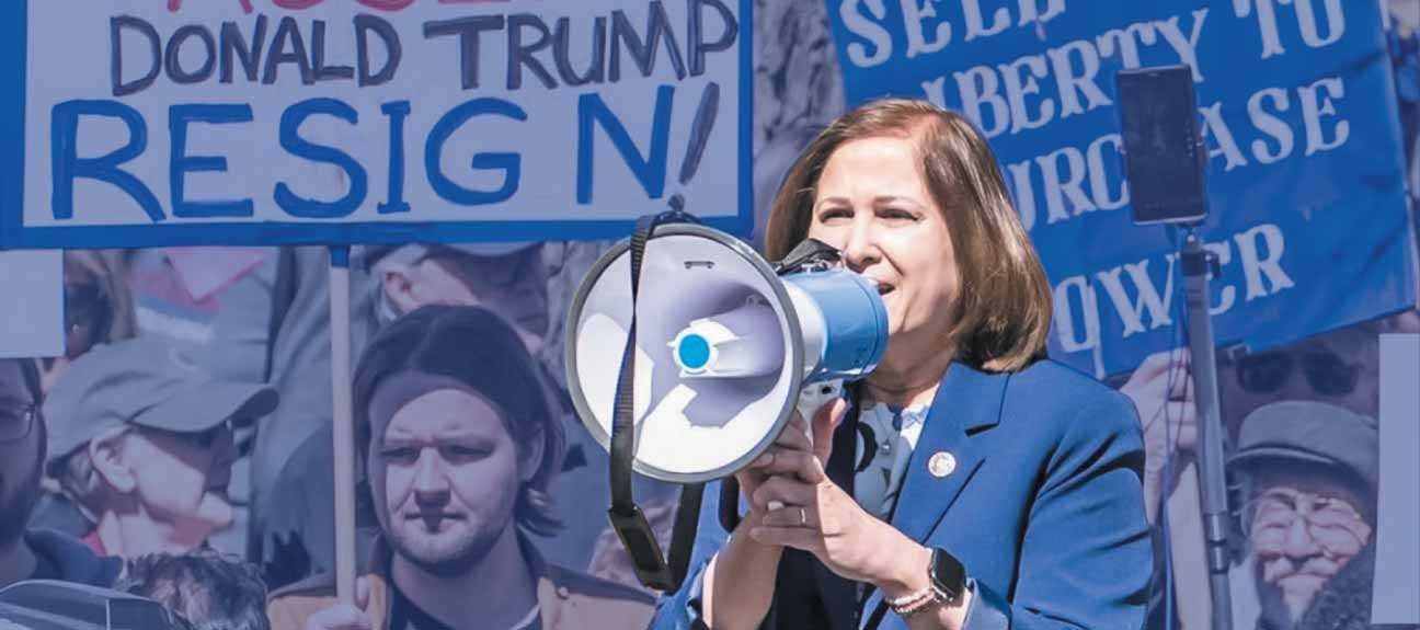 Ghazala Hashmi at a rally speaking through a megaphone